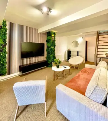 a living room with a couch and a tv in a room at Charmante maison de village in Pennautier