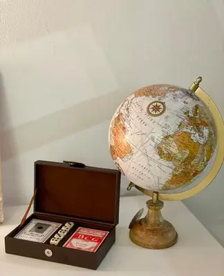 a globe sitting next to a box with a remote control at Charmante maison de village in Pennautier