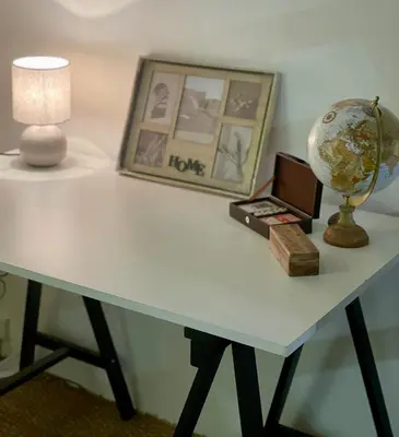 a table with a laptop and a globe on it at Charmante maison de village in Pennautier