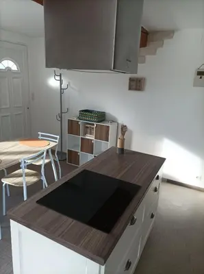 a kitchen with a wooden counter top and a table at Chez Sabine La campagne BIS in Narbonne