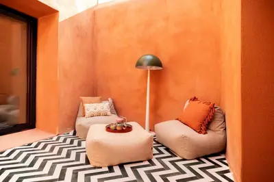 a living room with two chairs and a lamp at Maison Zellige - Rooftop - Gruissan Center in Gruissan