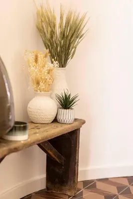 two vases sitting on a wooden table with plants at Maison Zellige - Rooftop - Gruissan Center in Gruissan