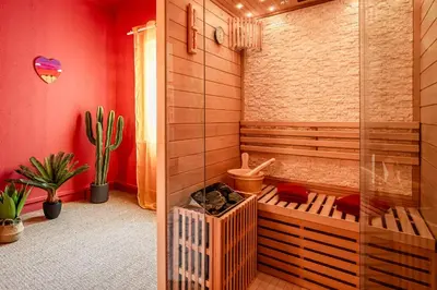 a bathroom with a tub and a shower and a plant at Casa Amor Balnéo Sauna in Lézignan-Corbières