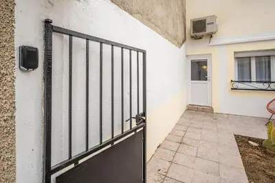 a door to a building with a gate in front at Casa Amor Balnéo Sauna in Lézignan-Corbières