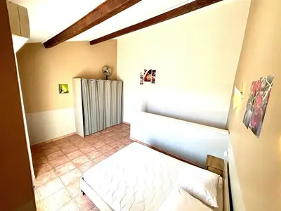 a small room with a bed and a radiator at Appartement 3 pièces Port la Nouvelle PN000-151 in Port-la-Nouvelle