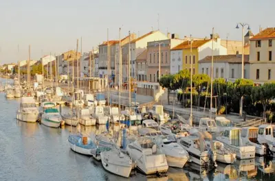 a bunch of boats docked in a harbor with buildings at Appartement 3 pièces Port la Nouvelle PN000-151 in Port-la-Nouvelle