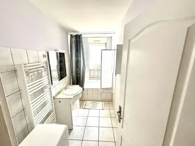 a white bathroom with a sink and a toilet at Appartement 3 pièces Port la Nouvelle PN000-151 in Port-la-Nouvelle