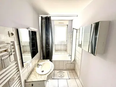 a small bathroom with a sink and a mirror at Appartement 3 pièces Port la Nouvelle PN000-151 in Port-la-Nouvelle