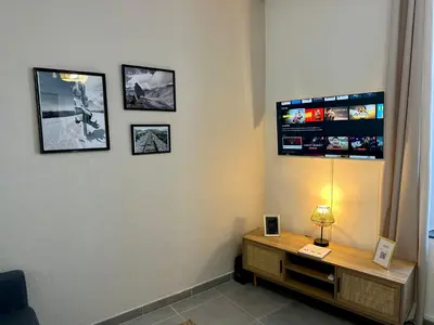 a room with a desk and pictures on the wall at Douce parenthèse in Carcassonne