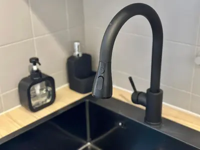 a kitchen sink with a black faucet on a counter at Douce parenthèse in Carcassonne