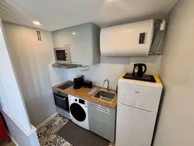 a small kitchen with a sink and a microwave at Appartement Studio PORT LA NOUVELLE PN480-046 in Port-la-Nouvelle