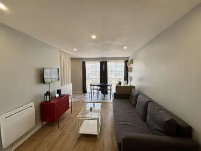 a living room with a couch and a table at Appartement Studio PORT LA NOUVELLE PN480-046 in Port-la-Nouvelle