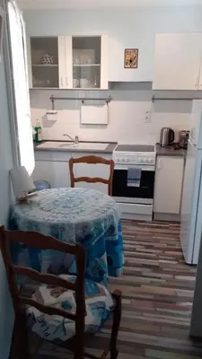 a kitchen with a table and chairs and a stove at Vue D Ansignan in Ansignan