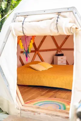 a bedroom with a bed in a tent at Centre Harmonia in Rennes-les-Bains
