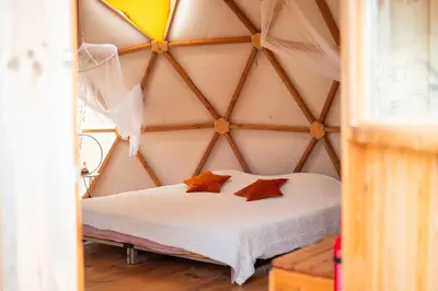 a bed with two pillows in a room at Centre Harmonia in Rennes-les-Bains