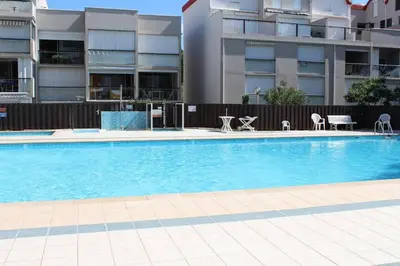 a large swimming pool in front of a building at Appartement Studio Cabine - proche plage du Grazel GN400-032 in Gruissan