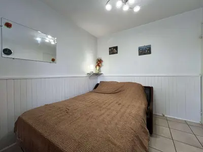 a bedroom with a bed and a mirror on the wall at Appartement Studio Cabine - proche plage du Grazel GN400-032 in Gruissan
