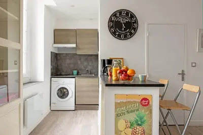 a kitchen with a counter with a washing machine at Aurore - Studio 1 in Carcassonne