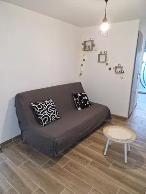 a room with a bed with pillows and a table at village house in Villegly