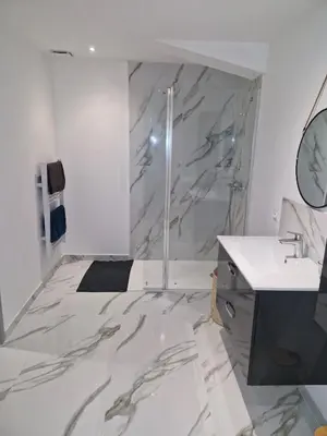 a bathroom with a marble shower and a sink at village house in Villegly