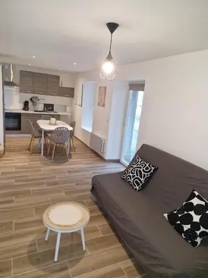 a living room with a bed and a kitchen at village house in Villegly