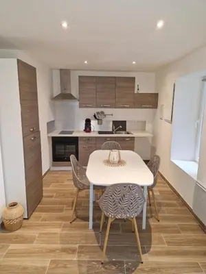 a kitchen and dining room with a table and chairs at village house in Villegly