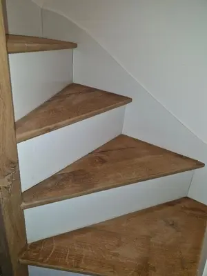 a set of stairs in a room with wooden floors at village house in Villegly
