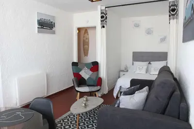 a bedroom with a bed and a couch and a chair at Appartement Studio PORT LA NOUVELLE PN480-074 in Port-la-Nouvelle