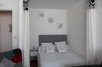 a bedroom with a bed with two pillows on it at Appartement Studio PORT LA NOUVELLE PN480-074 in Port-la-Nouvelle