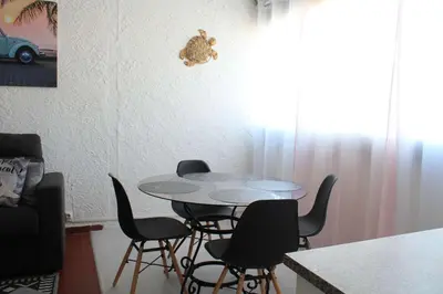 a dining room with a table and chairs at Appartement Studio PORT LA NOUVELLE PN480-074 in Port-la-Nouvelle