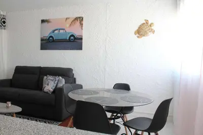 a living room with a table and a couch at Appartement Studio PORT LA NOUVELLE PN480-074 in Port-la-Nouvelle