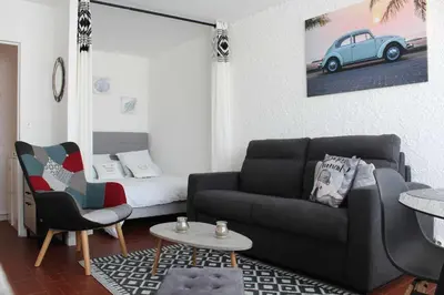 a living room with a couch and a table at Appartement Studio PORT LA NOUVELLE PN480-074 in Port-la-Nouvelle