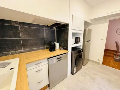 a kitchen with a refrigerator and a dishwasher at La Citadine in Carcassonne