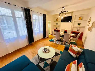 a living room with a couch and a table at La Citadine in Carcassonne