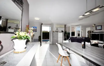 a kitchen and living room with a table and chairs at Nice Home In Lézignan-Corbières in Lézignan-Corbières