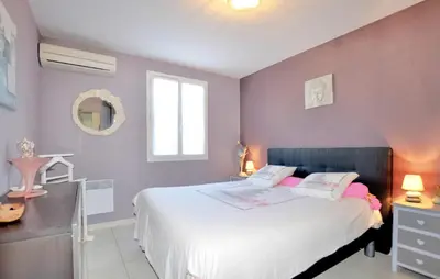 a bedroom with a large white bed with pink pillows at Nice Home In Lézignan-Corbières in Lézignan-Corbières
