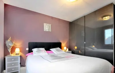 a bedroom with a large bed with pink walls at Nice Home In Lézignan-Corbières in Lézignan-Corbières