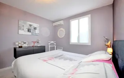 a bedroom with a white bed and a window at Nice Home In Lézignan-Corbières in Lézignan-Corbières