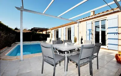 a patio with a table and chairs and a pool at Nice Home In Lézignan-Corbières in Lézignan-Corbières