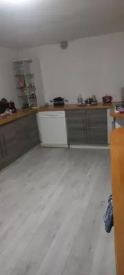 an empty kitchen with wooden counter tops in a room at Maison calme in Payrin-Augmontel