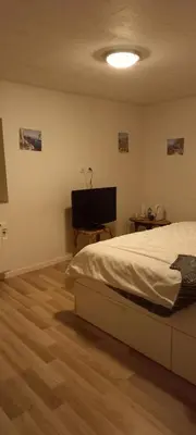 a bedroom with a bed and a flat screen tv at Maison calme in Payrin-Augmontel