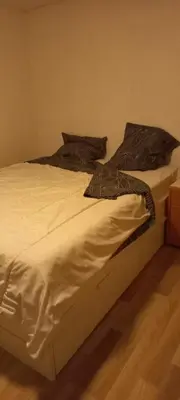 a bed with white sheets and pillows on it at Maison calme in Payrin-Augmontel