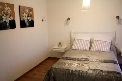 a bedroom with a bed with two pillows on it at La Ferme de Bellune in Mazères