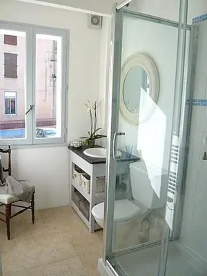 a bathroom with a glass shower and a sink at Chez LuLu Holiday Home in Olonzac