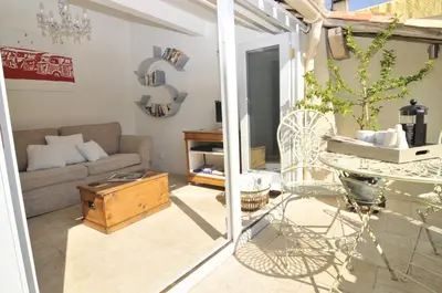 a living room with a couch and a table at Chez LuLu Holiday Home in Olonzac