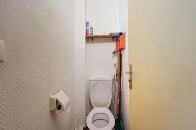 a small bathroom with a toilet in a stall at Charming T2 with terrace on the seafront in Port-la-Nouvelle