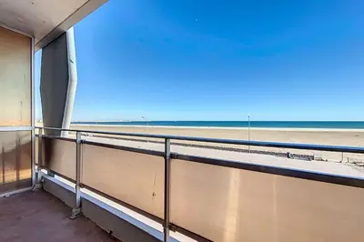 a balcony with a view of the beach at Charming T2 with terrace on the seafront in Port-la-Nouvelle