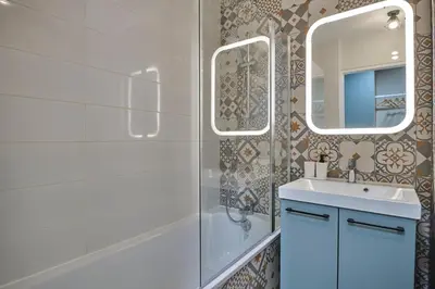 a bathroom with a sink and a mirror at Au Céladon Parking gratuit, WIFI, Terrasse, Piscine in Carcassonne