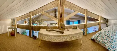 a bedroom with a bed with a large wooden bed frame at La Main du Cœur Chambre d'hôtes de charme à la campagne in Loubens-Lauragais