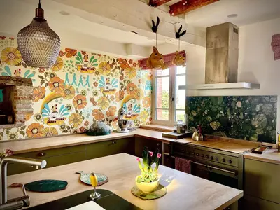 a kitchen with a sink and a stove top oven at La Main du Cœur Chambre d'hôtes de charme à la campagne in Loubens-Lauragais